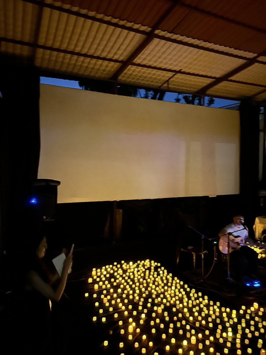 The candlelit floor and screen before the set begins.